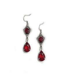 These dainty and elegantly ornate earrings are made with antique silver plated centerpieces, and silver tone settings, worn with stainless steel earring hooks. They are accented with bright ruby red glass crystals/jewels. Earrings measure 2 1/8" in length (including earring hooks) and 1/2" wide. More colors are available in our shop, along with matching chokers.If you don't see items with a color you want, feel free to ask about availability. Gothic Pierced Jewelry For Wedding, Gothic Dangle Earrings For Wedding, Silver Gothic Earrings For Formal Occasions, Ornate Earrings, Medieval Steampunk, Gothic Antique, Tvd Dr, Ornate Necklace, Red Gothic