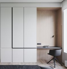 a bedroom with white closets and black chair next to the bed in front of it