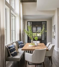 a dining room table with chairs and a bench