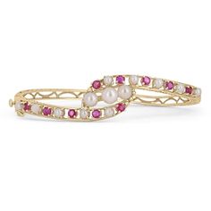 A timeless combination, a ruby and pearl bangle bracelet. Expertly crafted in glistening 14k yellow gold, this piece features genuine rubies set in strong prongs. The rubies are extraordinary gemstones with profound pinkish/red color paired with vivid saturation, tone, and an incandescent glow. Alternating seamlessly, pearls are also prong set showing off their excellent shine. Hand made etchings are found throughout the bangle. Fits small to average sized wrists. Setting Style: Bangle Setting Material: 14K Yellow Weight: 12.6 grams Main Stone: Natural Ruby Shape: Round Weight: 1.10Cts Total Stones: Ten Cut: Excellent Clarity: Very Good Color: Pinkish Red Luster: Very Good Treatments: Natural Secondary Stone: Natural Pearls Shape: Round Total Stones: 13 Luster: Excellent Treatments: Natura Ruby And Pearl, Solid Gold Bangle, Modern Bangle, Ruby Bangles, Pearl Bangle Bracelet, Ruby Bracelet, Modern Bracelets, Yellow Gold Bangle, Pearl Bangle