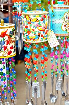 colorful tin canisters with spoons and forks hanging from them