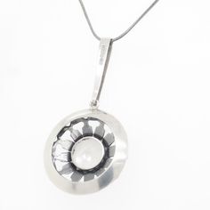 A fine Swedish modern pendant.  In solid silver with a bezel-set round cut rock crystal gemstone to the center of the pendant.  The pendant by Ge-ka Rolf Kaplan and is marked with a silversmith's initials 'G.K.'.  Simply a wonderful Swedish Modernist pendant!  (Chain for display purposes and not included with purchase.)  Date: Mid-20th Century  Overall Condition: It is in overall good, as-pictured, used estate condition with some fine & light surface scratches and other signs of expected light w Scandinavian Mid Century Modern, A Necklace, Modern Pendant, Rock Crystal, Bezel Setting, Crystals And Gemstones, Crystal Pendant, Round Cut, 20th Century