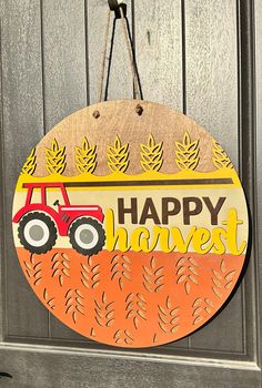 a sign that says happy harvest with a tractor on it