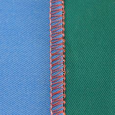 two different colors of fabric with red and blue stitching on them, one is green and the other is blue