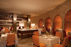 an empty restaurant with tables and orange chairs