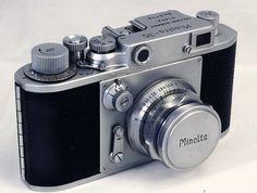 an old style camera sitting on top of a white table