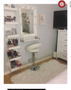 a room with a mirror, dresser and white furnishing on the floor in front of it