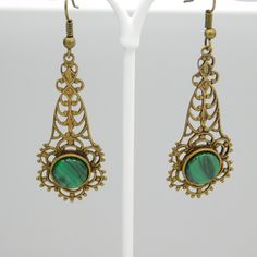 Long filigree earrings are a soft aged brass and have a green black glass stone at the bottom. These are so pretty and lightweight. The contrast of the brass and green is really nice. The earwires were missing so I did replace them. They are unmarked and in excellent condition. The drops alone measure 1 3/4 inch and from the top of the earwire to the bottom of the drop they are 2 1/4 inch. The kind of earring you find yourself reaching for all the time. Cute, dangly and comfortable. Find lots mo Nickel Free Green Metal Earrings, Green Ornate Filigree Earrings, Victorian Green Drop Earrings, Ornate Green Filigree Earrings, Nickel-free Green Metal Earrings, Green Filigree Drop Earrings, Victorian Green Dangle Earrings, Green Filigree Teardrop Earrings, Green Brass Earrings As Gift