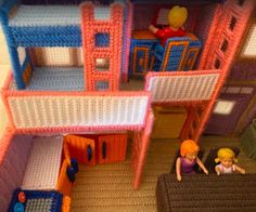 a doll house with furniture and dolls in the living room, including bunkbeds