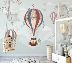 a child's bedroom with hot air balloons and teddy bears on the wall,