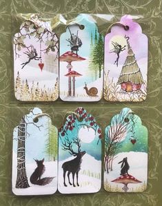 four tags with animals and trees on them