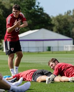 two soccer players are laying on the grass