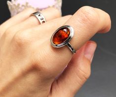 "Discover the perfect blend of elegance and boho chic with our Large Amber Ring in Sterling Silver, sized at 6 US. This captivating piece features an accentuating orange oval cabochon, making it a versatile choice for both women and men. Elevate your style with this colorful gemstone ring, a unique and timeless addition to your jewelry collection. An ideal gift for any occasion, this exquisite ring promises to leave a lasting impression. Shop now and add a touch of vibrant sophistication to your ensemble! ❗️  Vintage from before 2000 Size: 6 US Materials: Silver, amber Gem color: Orange Band color: Silver Style: Boho  And if you happen to be a gentleman shopping for a gift for your lady, here's a couple of tips: 1) There's no such thing as \"too much jewelry\". 2) Any woman would love jewe Big Necklace, Silver Heart Ring, Unique Jewelry Gifts, Layered Necklace Set, Amber Ring, Anniversary Jewelry, Bohemian Rings, Cabochon Ring, Exquisite Jewelry