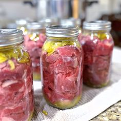 several jars filled with food sitting on top of a table