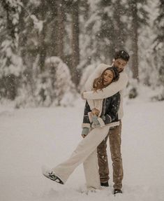 a man and woman hugging in the snow