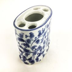 a blue and white vase sitting on top of a table