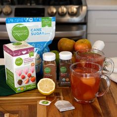 the ingredients for an apple cider tea sit on a cutting board