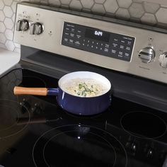 a pot of soup is sitting on the stove