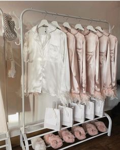 a rack filled with pink donuts next to white dresses