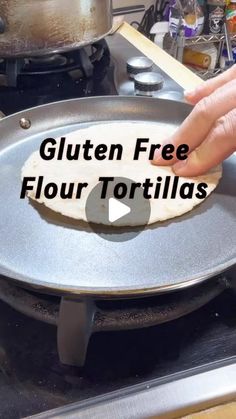 a person is flipping a tortilla in a frying pan on the stove