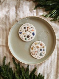 two ceramic ornaments sitting on top of a plate