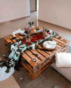 a table made out of wooden pallets with flowers on it