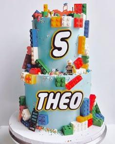 a birthday cake made to look like legos with the number 5 on it and building blocks