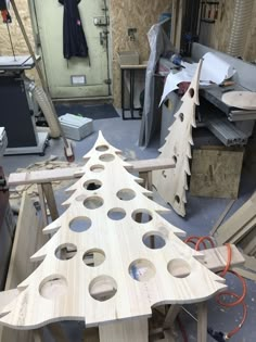 a wooden christmas tree with holes in it