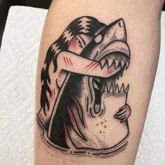 a black and white tattoo of a shark biting a man's head