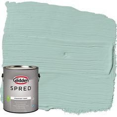 a paint can with a blue green color on the wall and it is being used as a