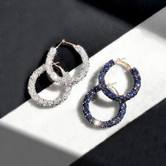 these glitzy hoop earrings are definitely a must-have for summer! ☀️  They are crafted with crystal embellishments on classic hoops, will catch all the shine while being outdoor enjoying the sunshine.   Coordinate yours with simple white t-shirt and jeans or sequined dresses for maximum wow-factor. 🌟 Click to shop. ⭐️ 💕 #hoopearrings #crystalhoops #glitzearrings #huggieearrings #navyblueearrings #sequinsearrings #glitterearrings✨ #silverhoops #summerearrings #eotd  #whattowear #standwithsmall Glamorous Crystal Rhinestone Hoop Earrings, Glamorous Rhinestone Crystal Hoop Earrings, Blue Hoop Earrings For Party, Hoop Earrings With Rhinestones And Cubic Zirconia, Metal Hoop Earrings For Parties, Crystal Hoop Earrings For Party, Metal Bling Hoop Earrings For Parties, Bling Metal Hoop Earrings For Party, Silver Hoop Earrings For Party