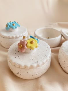 three small white dishes sitting on top of a table