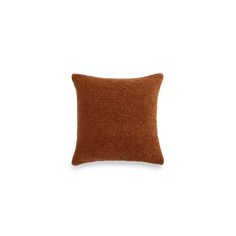 a brown pillow sitting on top of a white wall