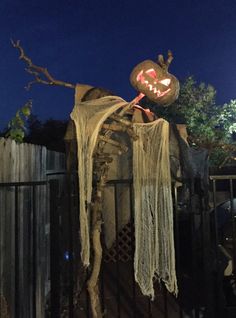 a halloween decoration on top of a fence