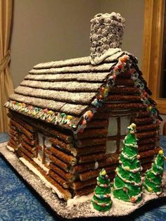 a gingerbread house is decorated with christmas trees