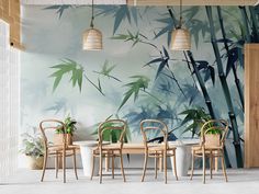 the dining room is decorated with bamboo plants and wallpaper, along with two hanging lamps