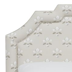 an upholstered headboard with white flowers on it