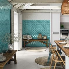 a kitchen with a table and chairs in front of a blue fish scale pattern on the wall