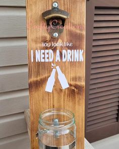 a wooden sign that says i need a drink