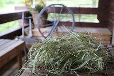 the grass is piled on top of the wooden table