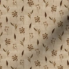 a white background with brown flowers and leaves on the fabric, it is very soft