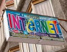 an internet sign hanging from the side of a building