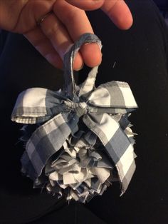 a person is holding onto a piece of fabric with a bow on it's end