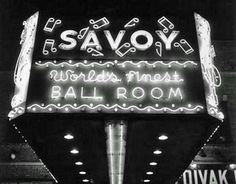 black and white photograph of the neon sign for savoy's world's most ball room