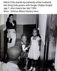 an old black and white photo shows two children in front of a chalkboard with writing on it