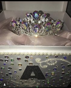 a tiara in a box with pearls on it