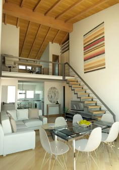 a living room filled with furniture and a stair case next to a glass top table