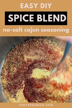 a person stirring spices in a pan with the words easy diy spice blend no - salt cajun seasoning