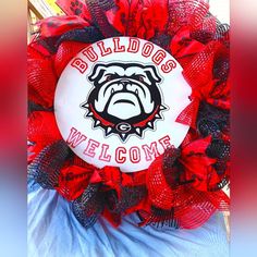 a red and black wreath with bulldog's on it that says, bulldogs welcome