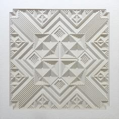 an intricately designed white paper with lines and shapes on it's surface, in the shape of a square